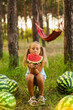 © Inna Vlasova - Cute girl eating watermelon at park in the forest