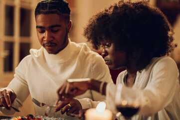 African american couple having romantic dinner date at home