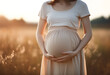 Radiant Expectations: Close-Up of Pregnant Woman Embracing her Belly, Bathed in Autumn's Golden Hour Sunlight