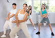 © JackF - Smiling females and males doing dance workout during group classes in fitness center