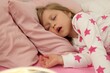 © New Africa - Little girl snoring while sleeping in bed
