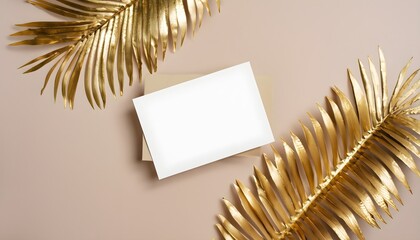 christmas background with card, Invitation card mockup with golden palm leaves on beige pastel background., copy space, Template blank of white paper mock up for branding and advertising, Top view, fl