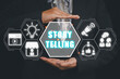 © Satori Studio - Story telling concept, Business person hand holding story telling icon on virtual screen.