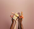 © May Thawtar - Hands with different skin colors holding beautiful flowers. AI generated