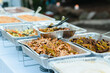 Outdoor catering of fajitas and other Mexican food in aluminum trays