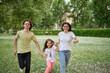 © boytsov - Smiling Family Running Across Summer Field Together. Mother Daughter son, hands together High quality photo