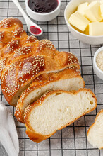Homemade Challah Bread With Sesame Seeds, Butter And Jam On A Grey Concrete Background. Sweet Bread. Selective Focus.