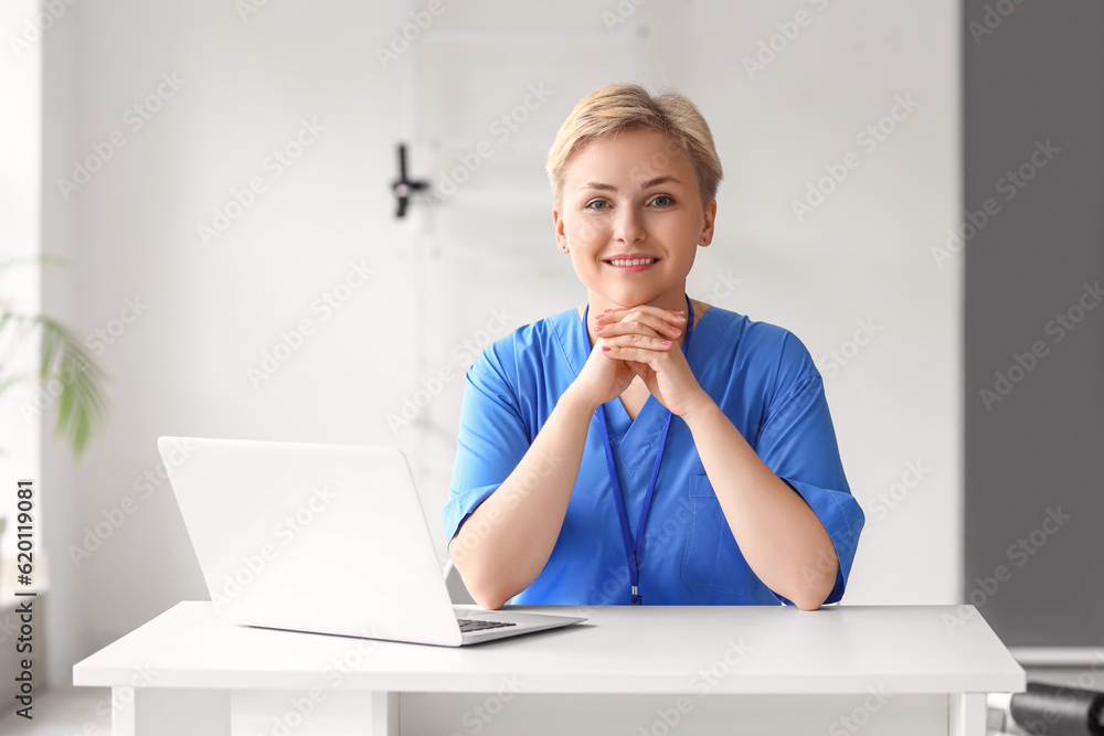 Female medical intern working at reception in clinic