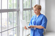 © Pixel-Shot - Female medical intern using laptop in clinic