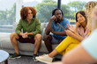 © WavebreakMediaMicro - Group of diverse people sitting on sofa, using tablet and talking in group therapy session