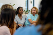 © WavebreakMediaMicro - Group of diverse people sitting on sofa and talking in group therapy session
