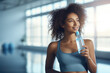 © Jasmina - Fit woman drinking water from the bottle in the gym