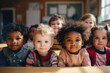 © txemag - Multiracial group of happy toddlers sitting in the classroom of the nursery looking at the camera