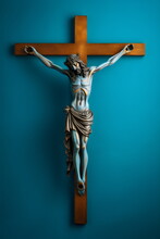 Metal Jesus On Simple Wooden Christian Crucifix Cross Isolated On Plain Blue Studio Background, Made With Generative Ai