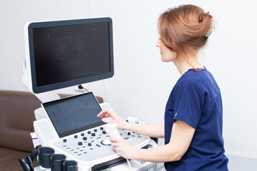 Wall Mural - Doctor woman doing ultrasound scanning diagnostic of thyroid gland sitting in office in clinic.