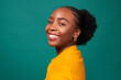 © Meeko Media - Beautiful Black woman smiles, studio teal background, fashion lifestyle portrait