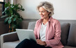 © Formatoriginal - Handsome attractive Middle aged woman looking at a laptop on the sofa in his living room at home. AI Generative