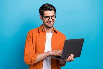 Fototapete - Portrait of handsome positive person beaming smile use wireless netbook coworking isolated on blue color background
