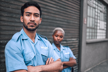 Wall Mural - Portrait, security or law enforcement and a serious man arms crossed with a black woman colleague on the street. Safety. focus and duty with a crime prevention unity working as a team in the city