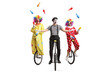 © Ljupco Smokovski - Two clowns and a mime riding unicycles and juggling