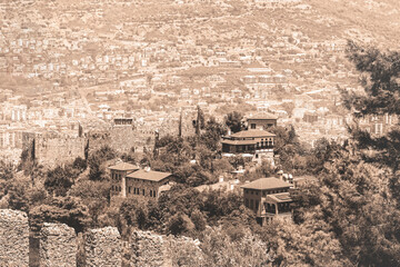 Wall Mural - Buildings inside Alanya castle. Famous tourist landmark, Alanya, Antalya region, Turkey. Old photo stylization, sepia