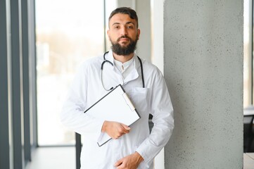 Portrait of a young arabian doctor standing in the the clinic