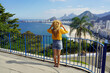 © zigres - Holidays in Brazil. Full length view of tourist girl looking at Rio de Janeiro cityscape with Copacabana beach, Rio de Janeiro, Brazil.