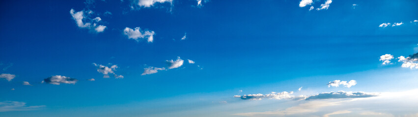Wall Mural - Blue sky with sparse clouds shot at 28 mm focal length