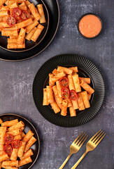 Wall Mural - Food photography of pasta, rigatoni with  roasted tomatoes, sauce, olive oil, durum, wheat, semolina, background, italian