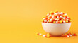 Bowl of Candy Corn on an Orange Background with Space for Copy