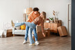 © Pixel-Shot - Young couple dancing in room on moving day