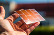 Flexible solar cells from ruthenium. Energy efficiency products. The concept of modern technology. A man holds a flexible solar cell battery in his hand. Sustainable technologies for ecology. Close up