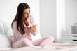 © Pixel-Shot - Sick young woman drinking hot tea in bed