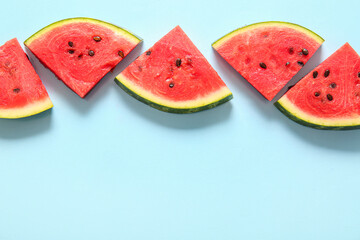 Wall Mural - Pieces of fresh watermelon on blue background