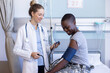 © Wavebreak Media - Diverse female doctor examining female soldier patient, measuring blood pressure at hospital
