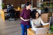© Wavebreak Media - Two diverse female casual business colleagues using tablet and computer, discussing work at desk