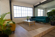 © Wavebreak Media - Casual office lounge break out area with sofas, coffee table, plants and big windows, copy space