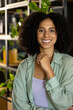 © Wavebreak Media - Portrait of happy biracial casual businesswoman with curly dark hair smiling in office