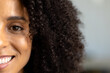 © Wavebreak Media - Half portrait of happy biracial casual businesswoman with curly hair smiling in office, copy space