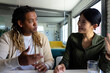 © Wavebreak Media - Two diverse casual business colleagues sitting at desk in discussion, having video call in office