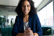 © Wavebreak Media - Happy biracial casual businesswoman in office having video call, smiling