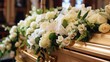 Funeral casket with white flowers in a church