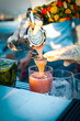 Close-up bartender hand making cocktail at rooftop bar
