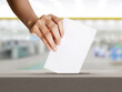 Hand holding ballot paper for election vote, Election concept.