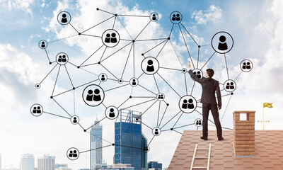 Wall Mural - businessman on house roof presenting networking and connection concept. mixed media