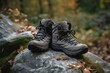 Hiking boots sitting on a rock in the middle of a forest