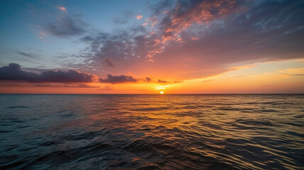 Wall Mural - Dramatic sunset over calm ocean water in the evening