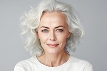 Beautiful Gorgeous 50s Mid Aged Mature Woman Looking At Camera Isolated On White. Mature Old Lady Close Up Portrait. Healthy Face Skin Care Beauty, Middle Age Skincare Cosmetics, Cosmetology Concept.