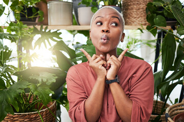 Wall Mural - Black woman, silly face and green house plant with comedy feeling happy feeling shy. African female person, girl and crazy with hand sign and funny pout with comic confidence and greenery with joke