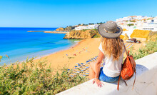Travel Destination In Portugal- Idyllic Beach In Algarve With Woman Enjoying The View